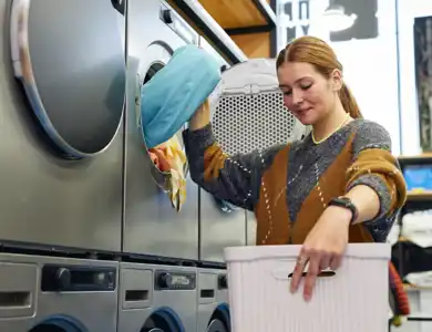 Woman Pulling Clothes Out Of The Dryer 1200X800